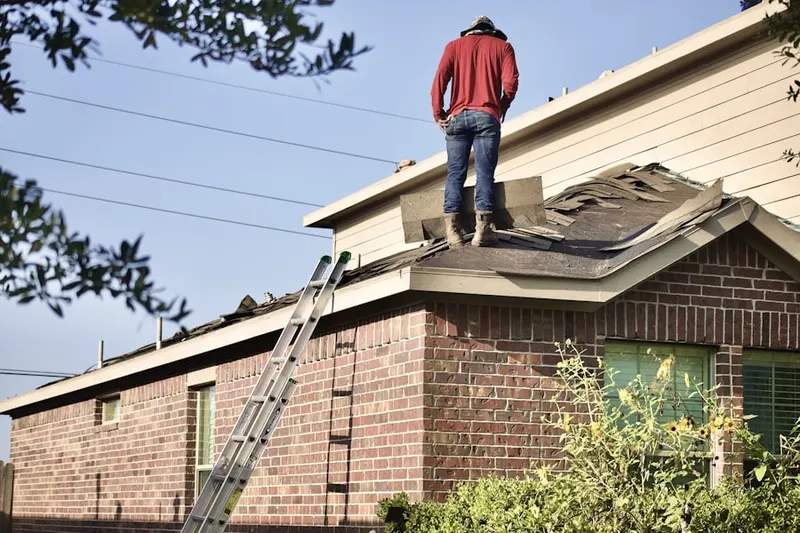Professional roofer working on a residential roof in Palm Beach Farms